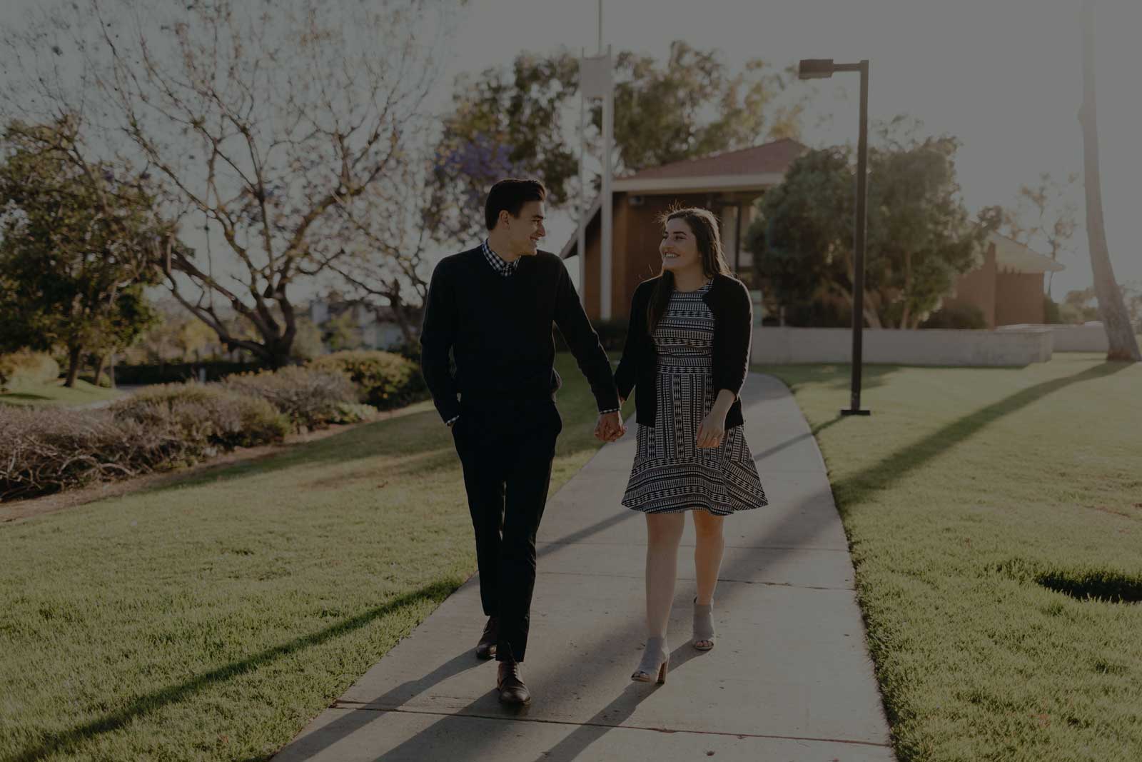 Scott and Ariana holding hands walking in front of Good Shepherd Chapel